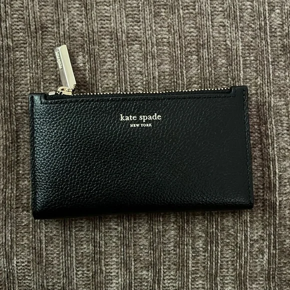 Kate spade bi-fold Spencer Slim in black with gold tone hardware. - Picture 1 of 6